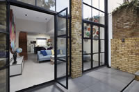The addition of Clement metal framed screens has brought 'the outside in' to this superb London home.